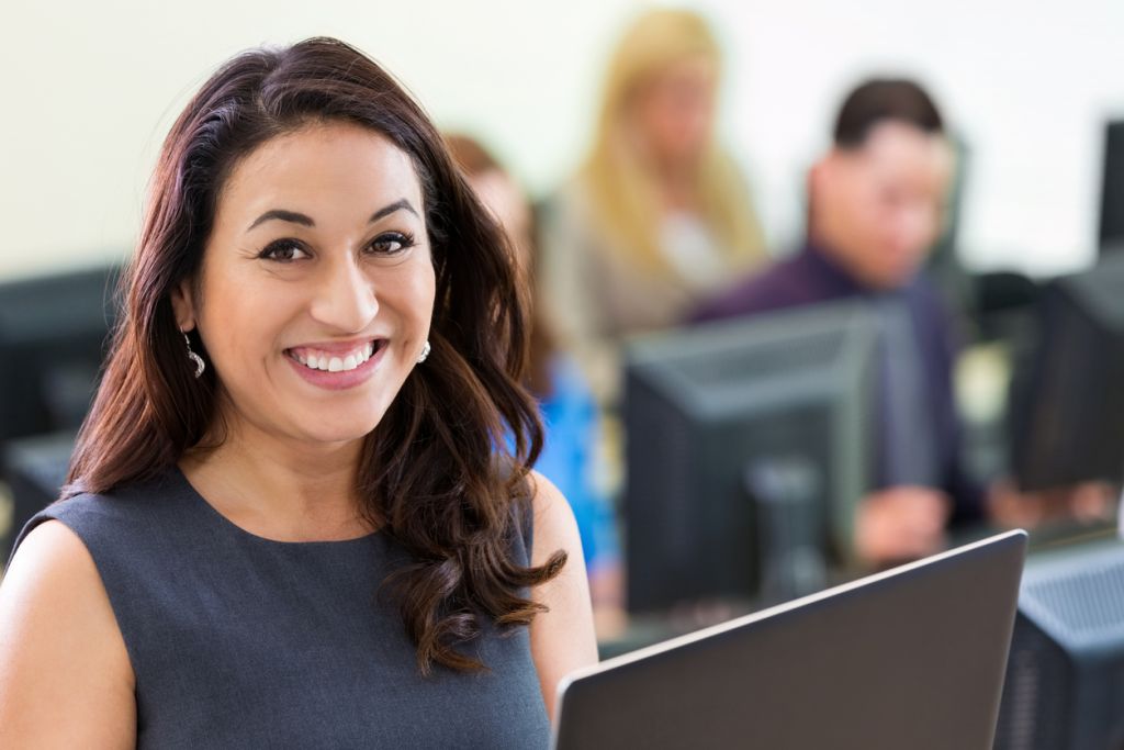 Title clerk smiling from behind computer